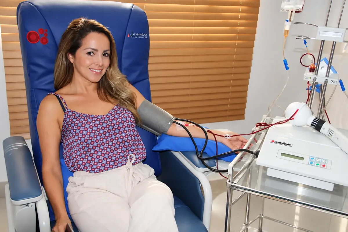 Seated patient connected to a Hemofenix device during an apheresis session
