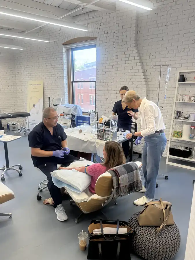 Patient and several professionals during an apheresis session in Boston